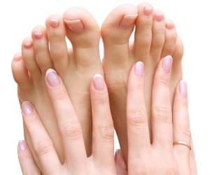 A woman showing her manicure and pedicure results