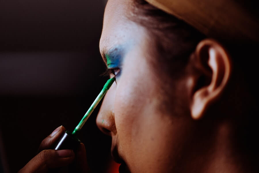 woman applying eye makeup