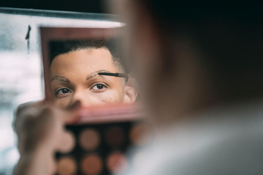 person filling their eyebrows in with an eyebrow pencil