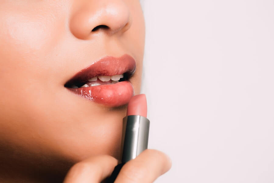 woman applying lipstick