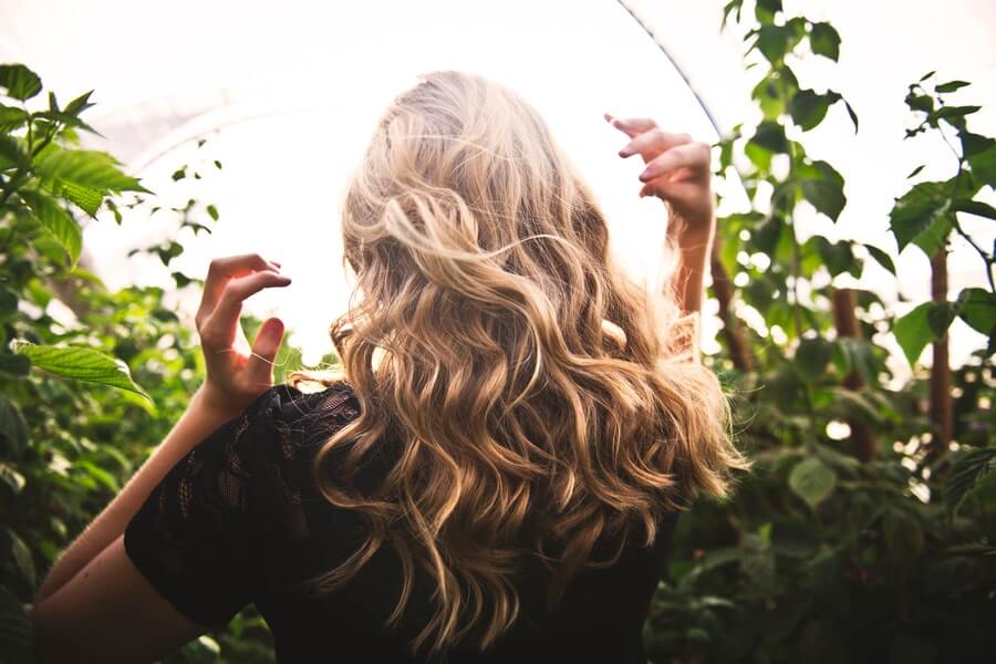 blonde haired woman with her back to the camera