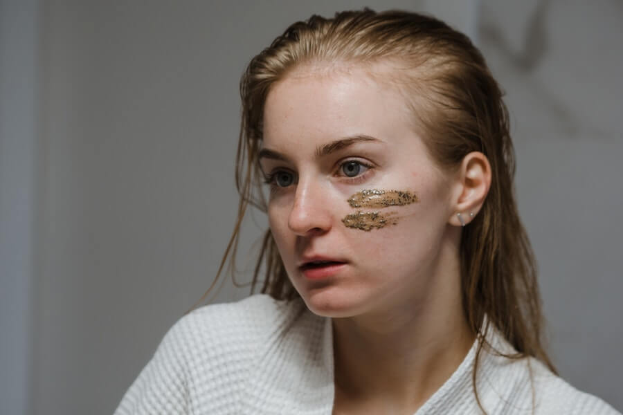 woman applying face mask to skin