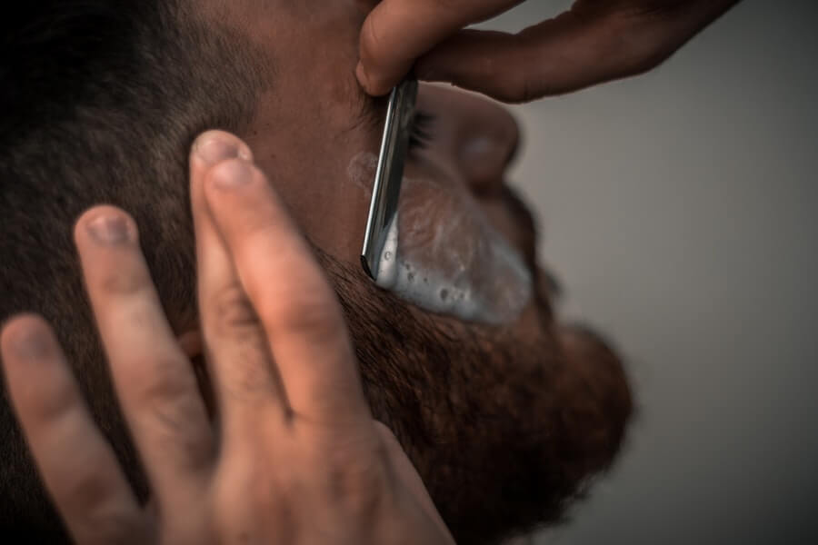 man having face shaved