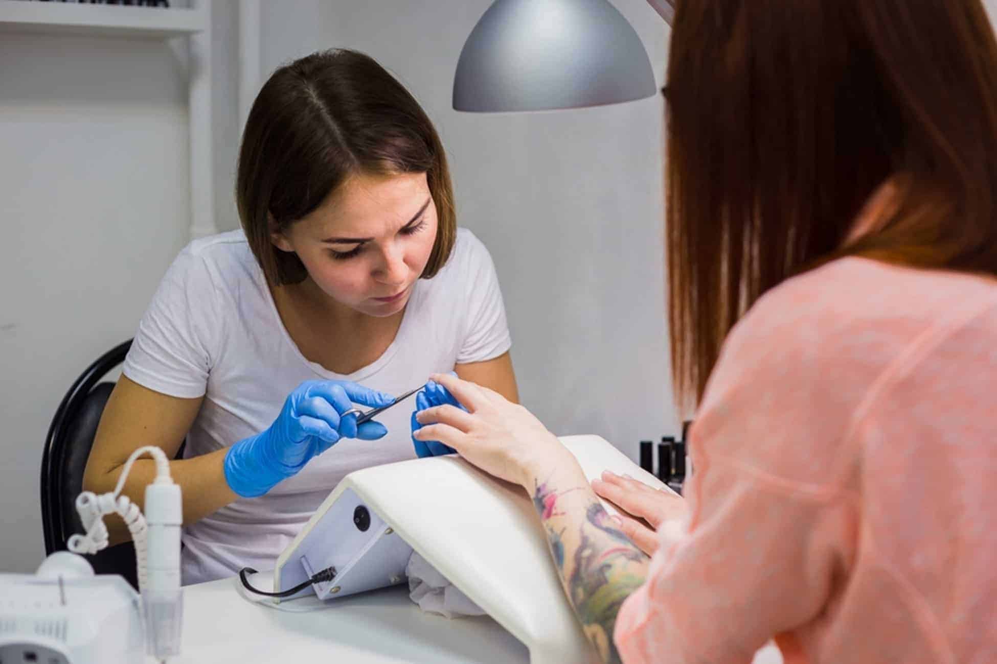 Women having nails cut by nail technician