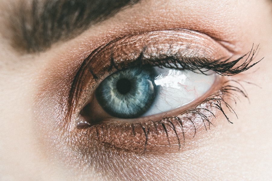 close up of a blue eye without eyelash extensions