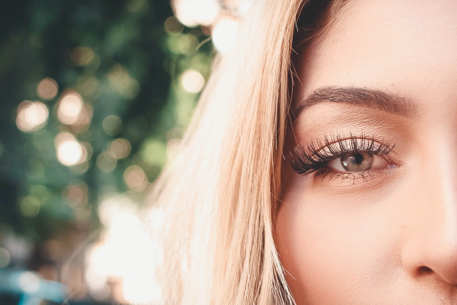 a close up of a woman with eyelash extensions