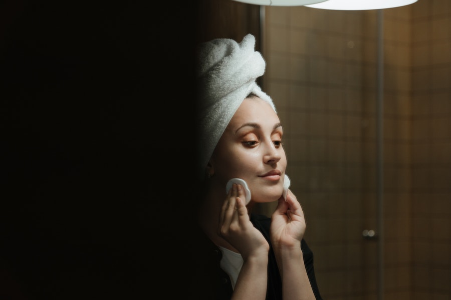 woman rubbing face