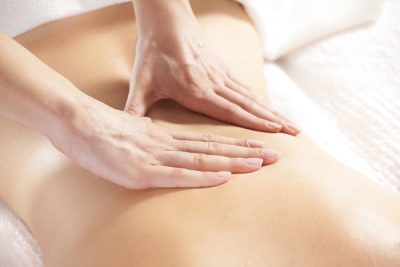 women receiving massage on lower back-min