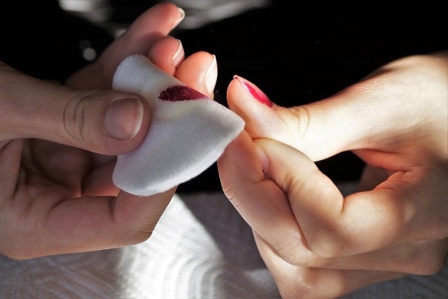 person removing nail polish
