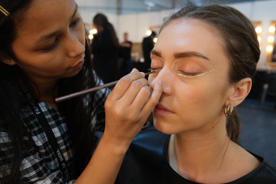 a makeup artist applying makeup