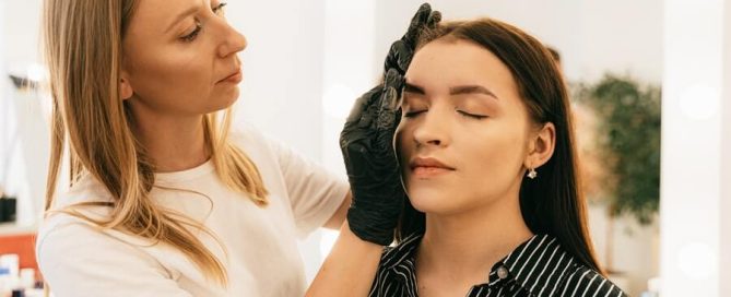 a makeup artist applying makeup to their client