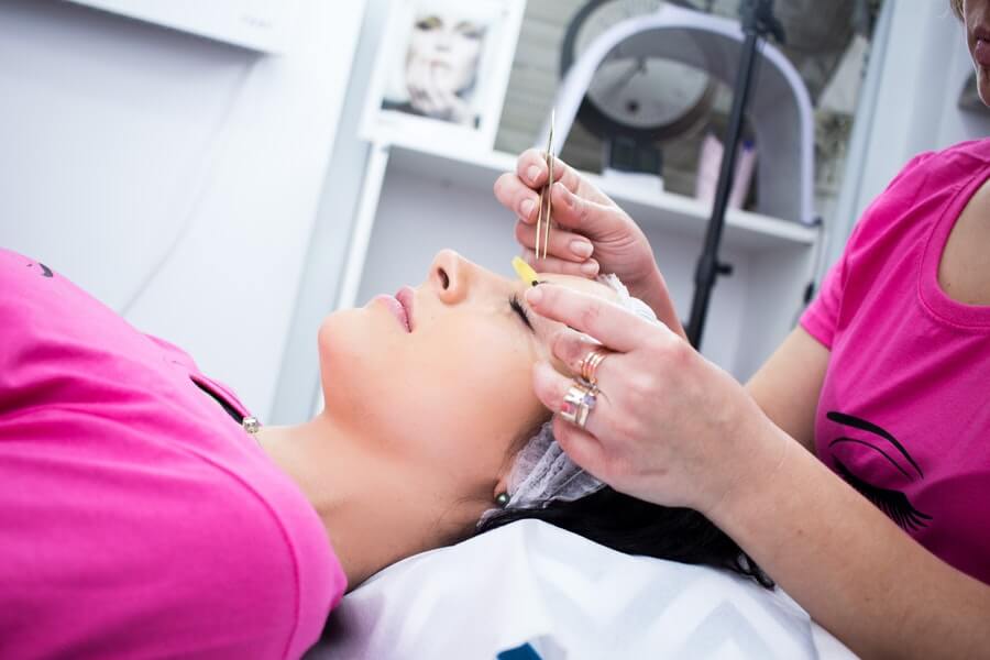 a technician with a waxing certificate removing facial hair