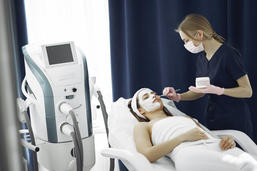 a skin therapist applying a facial treatment