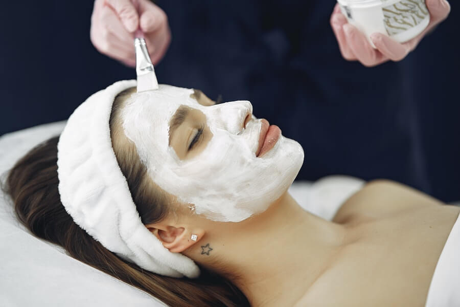 a skin therapist giving a facial treatment