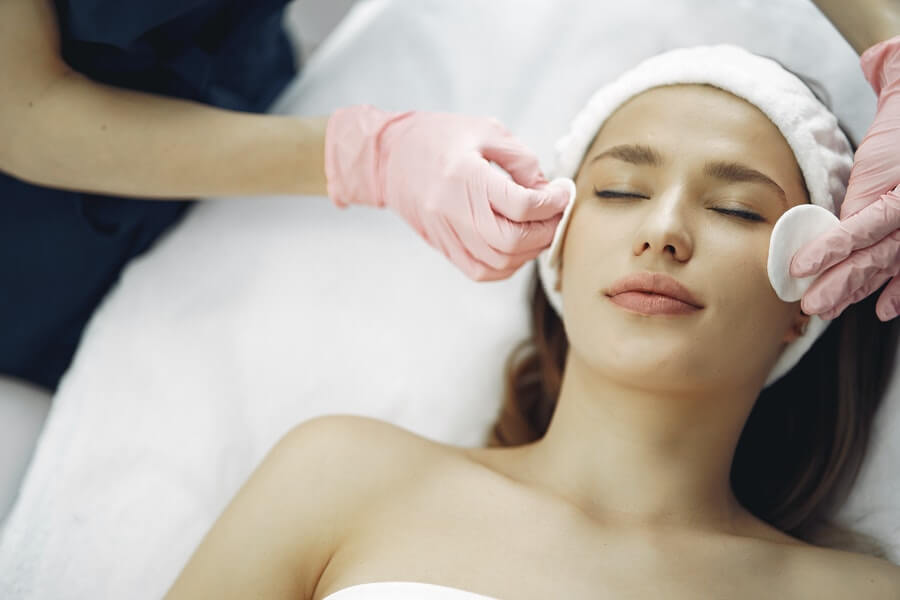 a skin therapist preparing their clients skin