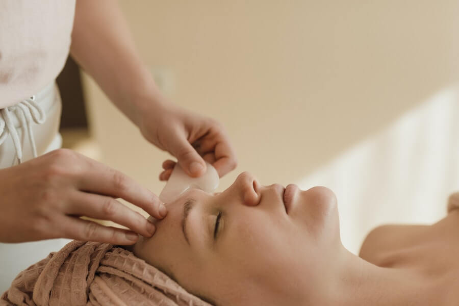 skin therapist providing facial treatment