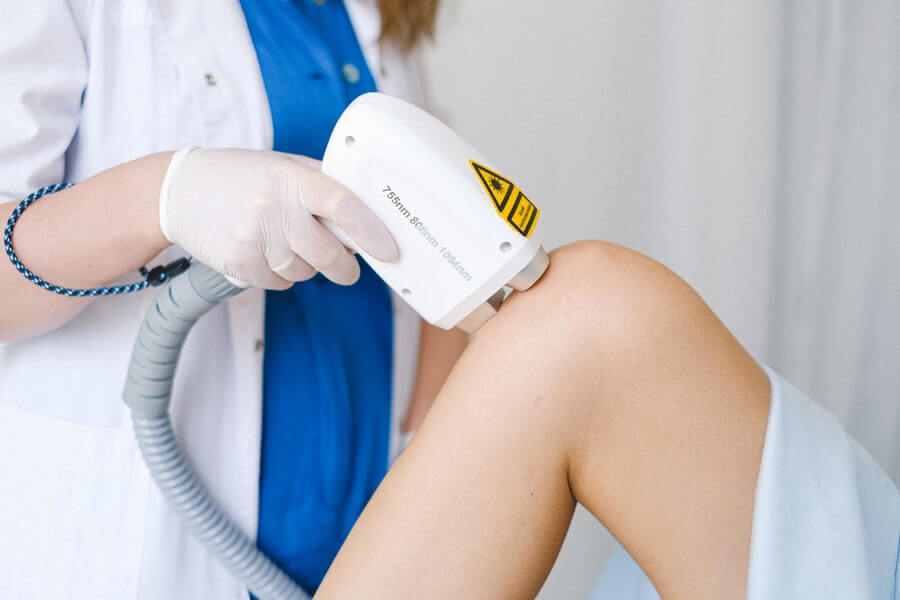 a technician with a waxing certificate removing body hair